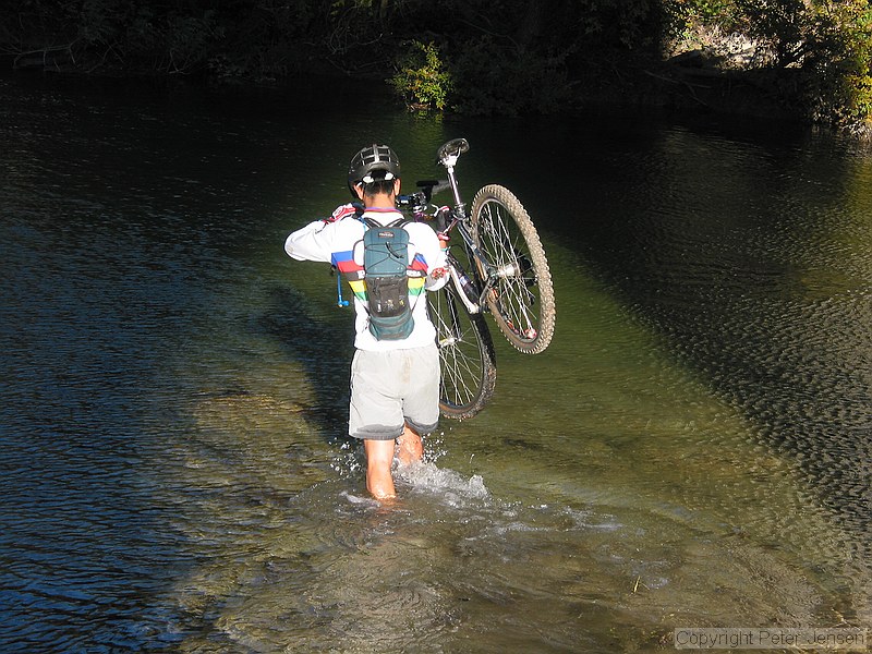 mountain biker crossing the stream