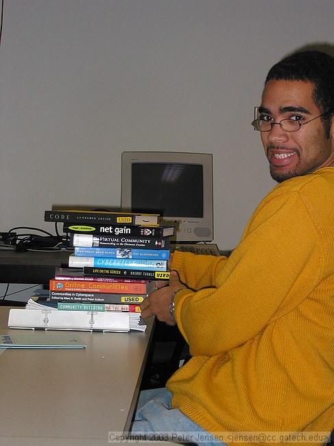 Amon with the pile of books we *all* brought to our online communities final