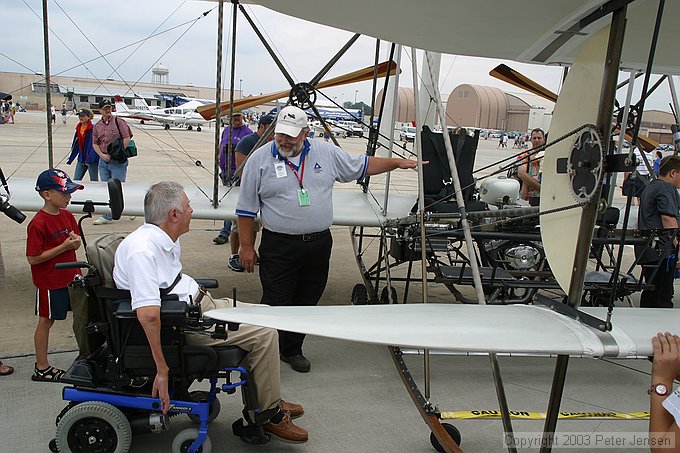USU gentleman explaining the Wright Flyer to visitors