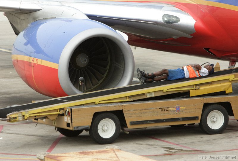 Southwest ramp worker taking a break while waiting for bags to arrive.