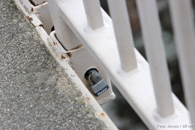 mini-padlock, presumably so the railings can be removed before floods