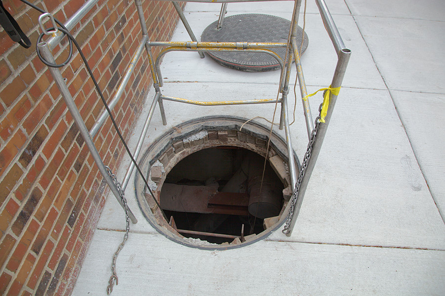 manhole cover open to shut down a steam vavle for repairs across the street