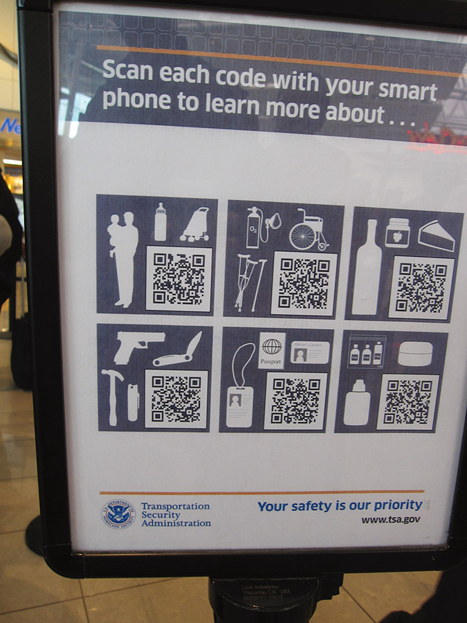 This sign totally needs to be upgraded. Anybody up for printing a series of variously scaled QR codes in sticker form?