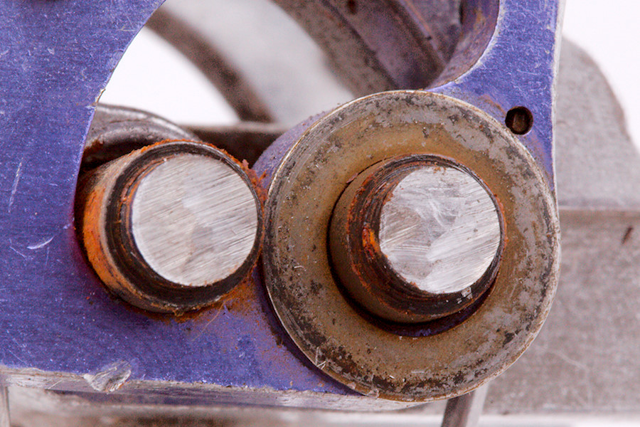 rust on solid steel cam axles and springs; grinding marks are from disassembly, as is the indent in the aluminum cam lobe visible in the lower left of this photo
