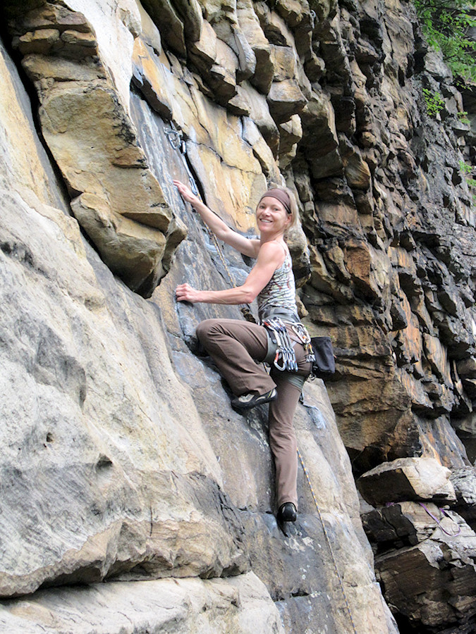 climber on one of the 5.10s next to the leaning block in Sandstonia