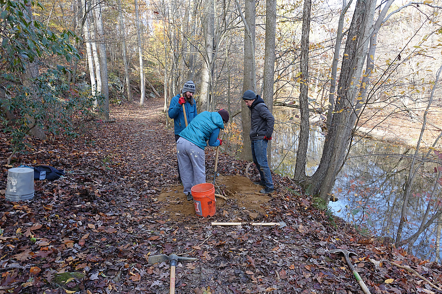 removing an old metal fencepost in the trail