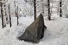 ugly but effective tent pitch - could have slept under the stars but was afraid wind might pick up again. Except the skis all anchors are 2' sticks deadmaned in to the snow.