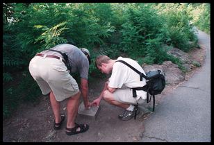 dad and peter look at USGS marker