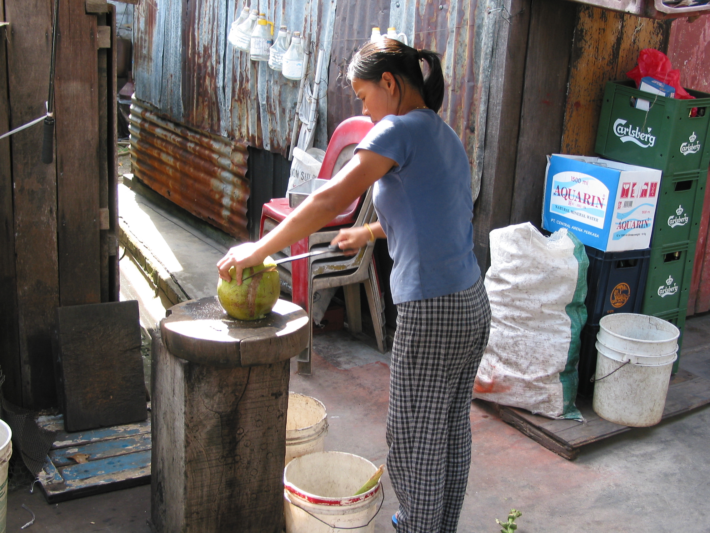 opening a coconut with a machete