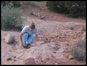 Ana examining rocks