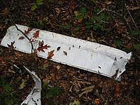 random airplane parts; the long rectangular piece appears to be an aileron from a Cessna 152-class plane, and the mangled bit seems to be part of a gas tank on a wing.