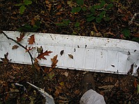 random airplane parts; the long rectangular piece appears to be an aileron from a Cessna 152-class plane, and the mangled bit seems to be part of a gas tank on a wing.