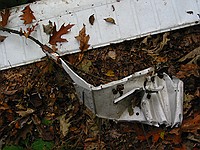 random airplane parts; the long rectangular piece appears to be an aileron from a Cessna 152-class plane, and the mangled bit seems to be part of a gas tank on a wing.