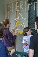 sorority sisters creating homecoming decorations