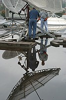 contractors disassembling the old dish