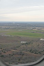 water tank and McKinney Falls State Park visible while on final for runway 35L