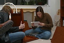 Callie and Kayla assembling the bed-side tables