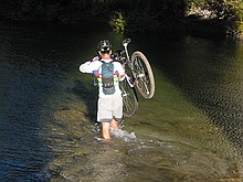 mountain biker crossing the stream