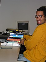 Amon with the pile of books we *all* brought to our online communities final