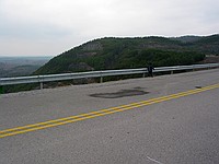 a pilot's son looks over the edge of the dam