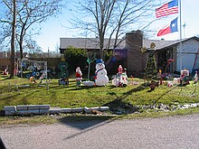 Christmas season disguises some of the junk in the yard here, but this house is always a POS dump