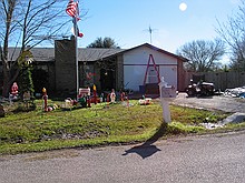 Christmas season disguises some of the junk in the yard here, but this house is always a POS dump