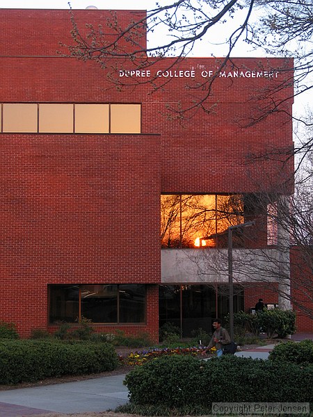 sunset reflected in the window of the Dupree College of Management