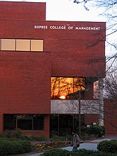 sunset reflected in the window of the Dupree College of Management