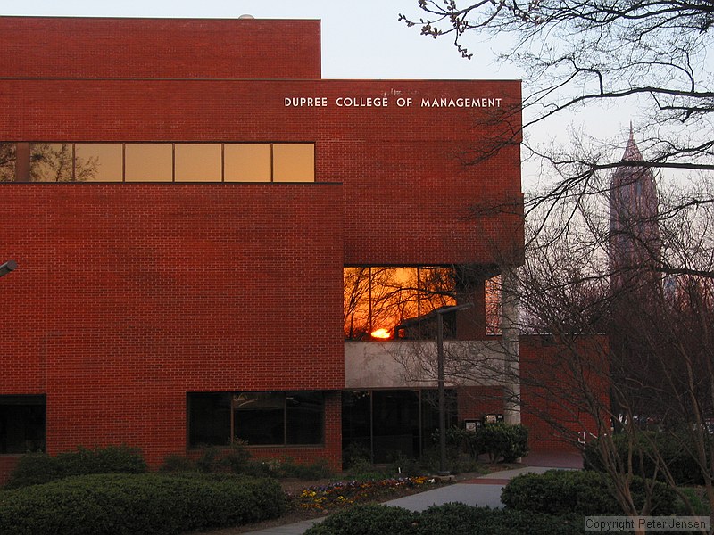 sunset reflected in the window of the Dupree College of Management