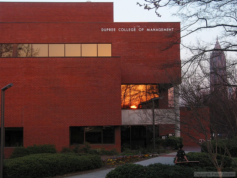 sunset reflected in the window of the Dupree College of Management