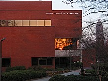 sunset reflected in the window of the Dupree College of Management