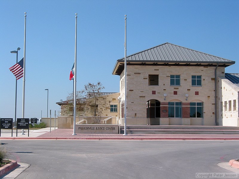 flags at half staff at the Pflugerville Justice Center