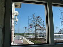 flags at half staff at the Pflugerville Justice Center