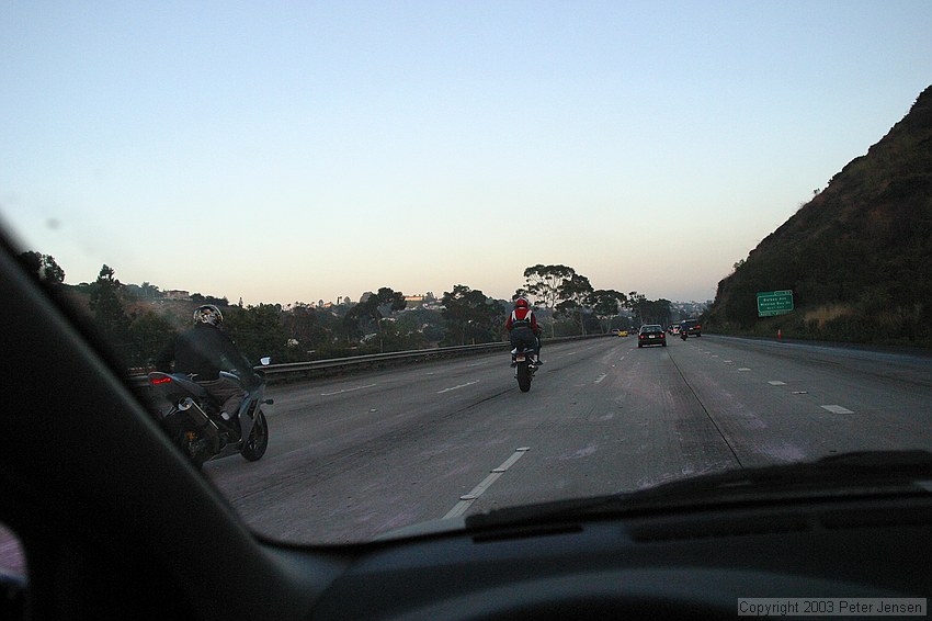 goofy motorcycle guys showing off by doing wheelies on San Diego