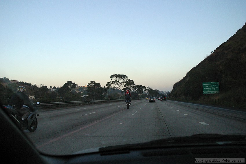 goofy motorcycle guys showing off by doing wheelies on San Diego