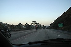 goofy motorcycle guys showing off by doing wheelies on San Diego