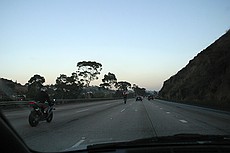 goofy motorcycle guys showing off by doing wheelies on San Diego