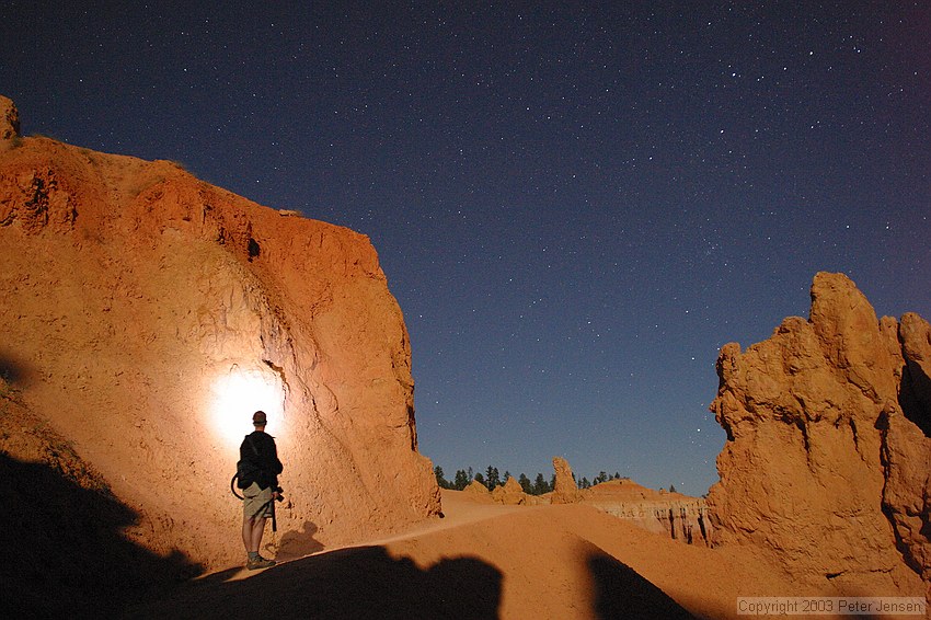 an experiment in light painting -- Charlie was using a single bright white LED on a keychain flashlight.  The rest of the light is provided by the moon