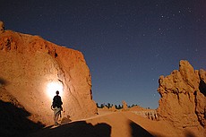 an experiment in light painting -- Charlie was using a single bright white LED on a keychain flashlight.  The rest of the light is provided by the moon