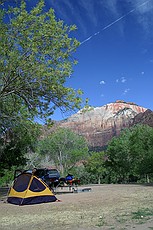 tent set up in our camp with a neat contrail going by