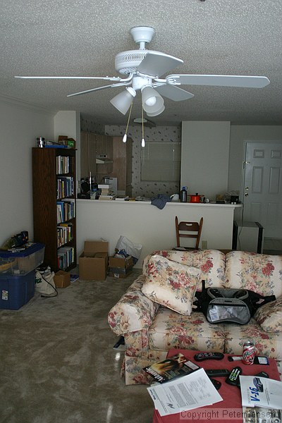 living room, my crap piled in a corner, kitchen