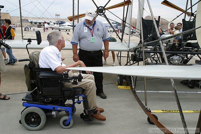 USU gentleman explaining the Wright Flyer to visitors