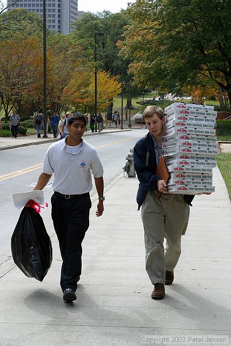 IEEE folks taking empty pizza boxes out to the dumpster after a meeting