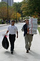 IEEE folks taking empty pizza boxes out to the dumpster after a meeting