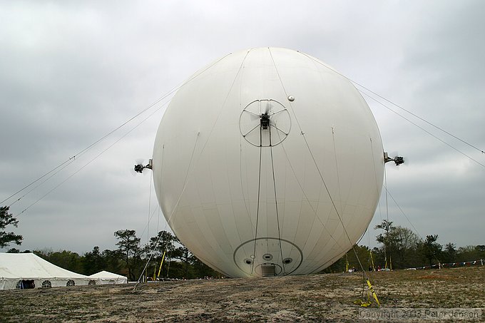 rear view of the airship showing port, rear, and starboard thrusters.  Metal disc on the middle upper right is the helium vent