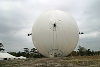 rear view of the airship showing port, rear, and starboard thrusters.  Metal disc on the middle upper right is the helium vent