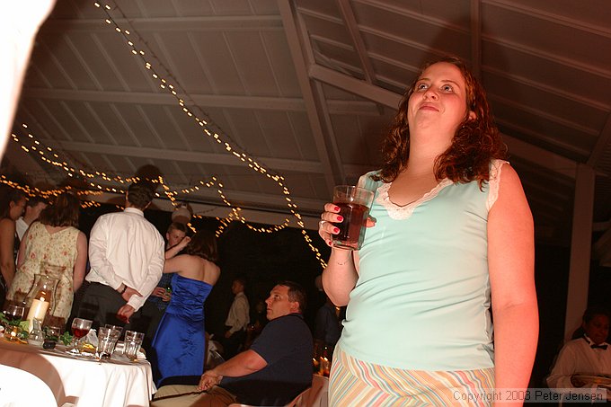 sneak shot of Lauren with flash bounced off of somebody's red dress