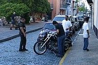 locals talking with a police officer about this bike