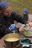 Laura cutting up a green bell pepper for dinner
