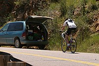 unfff.... it's a long climb.  I guess he's planning on putting the helmet on for the downhill or something.